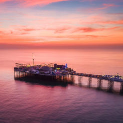 Birdseye view of Brighton Palace Pier during sunset.